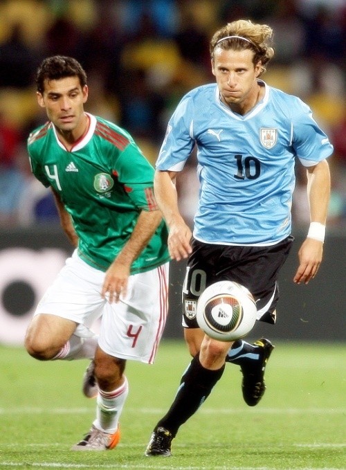 Rafael Marquez and Diego Forlan of Uruguay