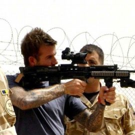 Britain's soccer player David Beckham is shown some of the weapon systems used by front line troops during a visit to Camp Bastion in Afghanistan