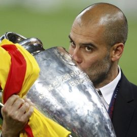 Barcelona's manager Guardiola kisses the trophy after their Champions League final soccer match victory against Manchester United in London
