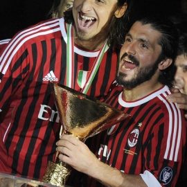 AC Milan's Ibrahimovic and teammate Gattuso celebrate with the trophy after winning their 18th Italian Serie A title at the end of their match against Cagliari at the San Siro stadium in Milan