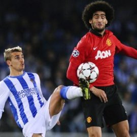 Marouanne Fellaini of Manchester United disputes possession with Real Sociedad's Antoine Griezmann.