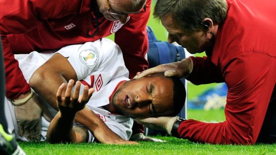 Theo Walcott being treated by England medics
