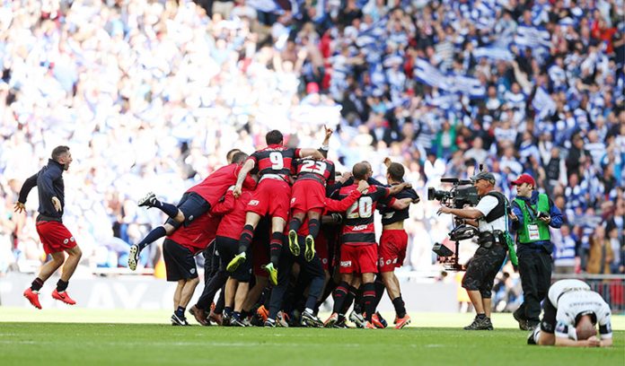 QPR celebrate at the end of the match after gaining promotion