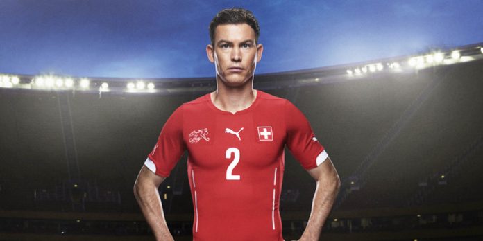 Stephan Lichtsteiner in the 2014 Switzerland Home Kit that features PUMA's PWR ACTV Technology