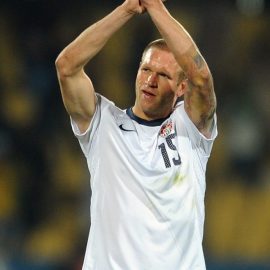 A dejected Jay DeMerit of USA applauds the supporters at full-time