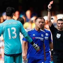 Michael Oliver shows Courtois a red card for denying Gomis a clear goalscoring opportunity