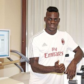 Mario Balotelli in a AC Milan shirt after completing his move from Liverpool