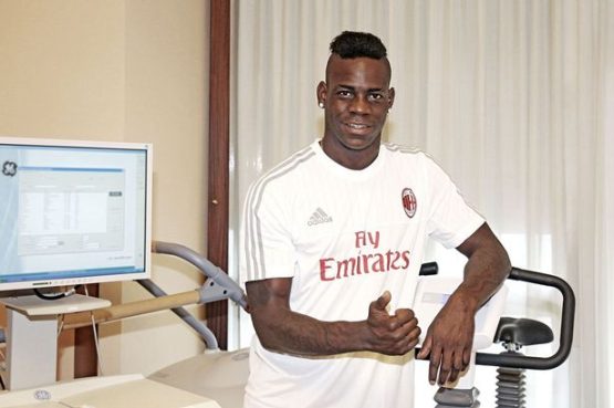 Mario Balotelli in a AC Milan shirt after completing his move from Liverpool