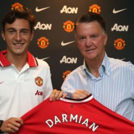 Darmian holding the Manchester United shirt with Van Gaal after completing transfer