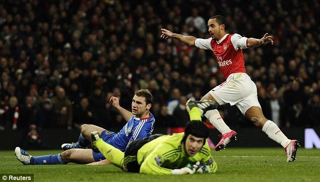 Theo Walcott celebrating after scoring against Chelsea in 2010