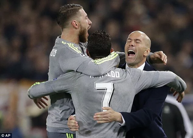 Zinedine Zidane celebrating a goal with Sergio Ramos and Cristian's Ronadlo.