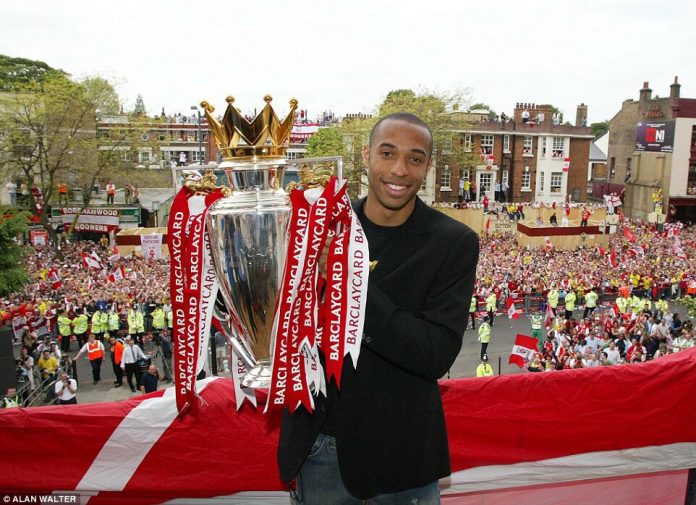 Thierry Henry with the Premier League title in 2002
