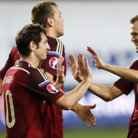 Russia's Alan Dzagoev, Artem Dzyuba and Denis Cheryshev celebrate a goal against Liechtenstein during their Euro 2016 Group G qualifying soccer match at the Arena Khimki outside Moscow