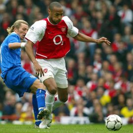 Arsenal's Thierry Henry (R) is challenge