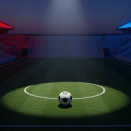 Empty floodlit stadium corner section with red and blue accent lighting, single football on centre spot under spotlight.