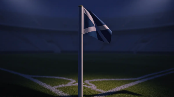 Empty stadium corner during evening floodlighting with navy-blue atmospheric mood and dramatic shadows across pitch markings.