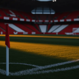 Empty floodlit stadium corner at dusk with Swiss red and white accent lighting across the bowl.